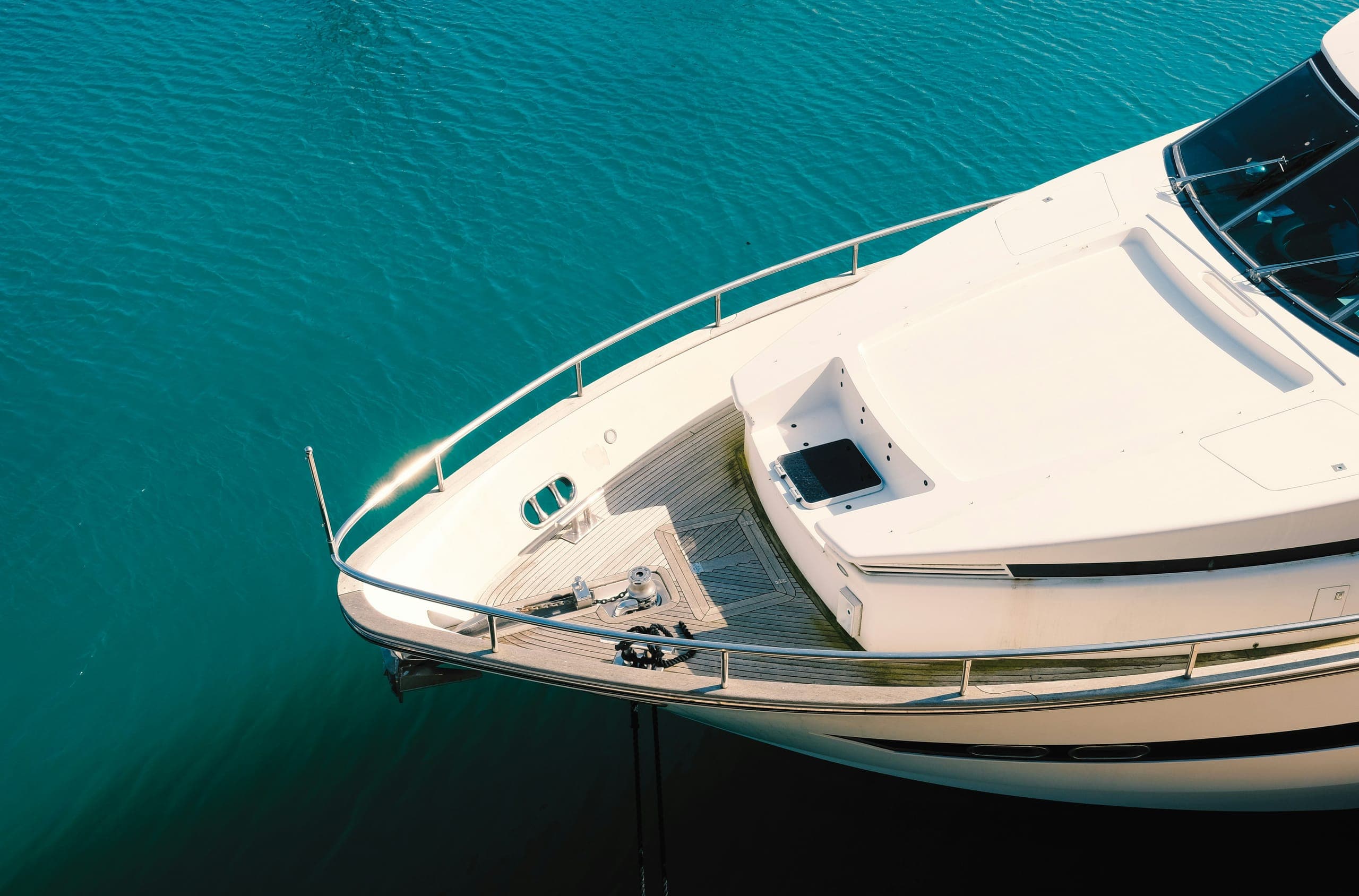 Bow of a luxury yacht on turquoise water