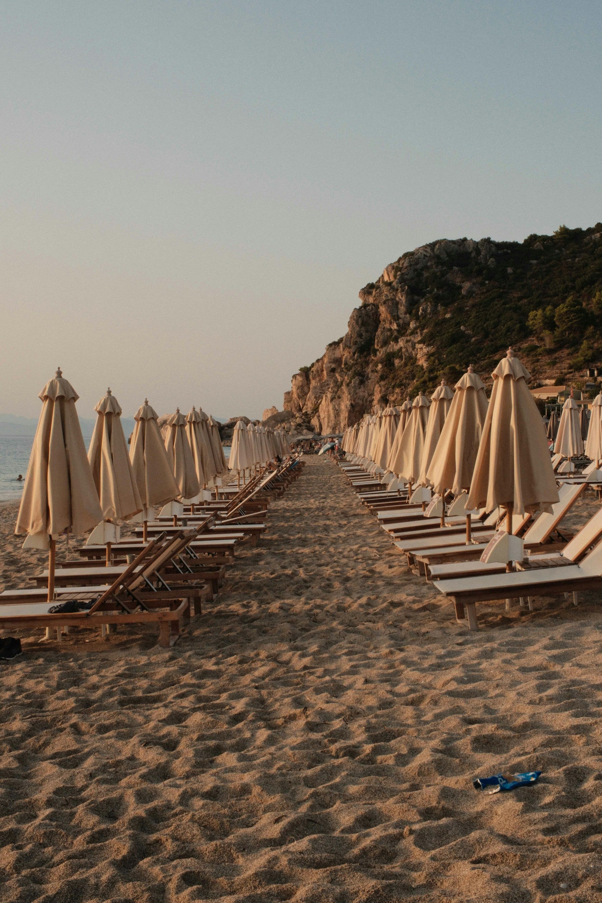 Rows of beach loungers at sunrise